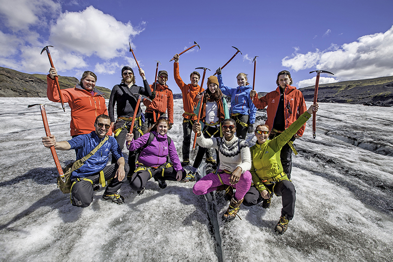A group of hikers in full gear on a glacier