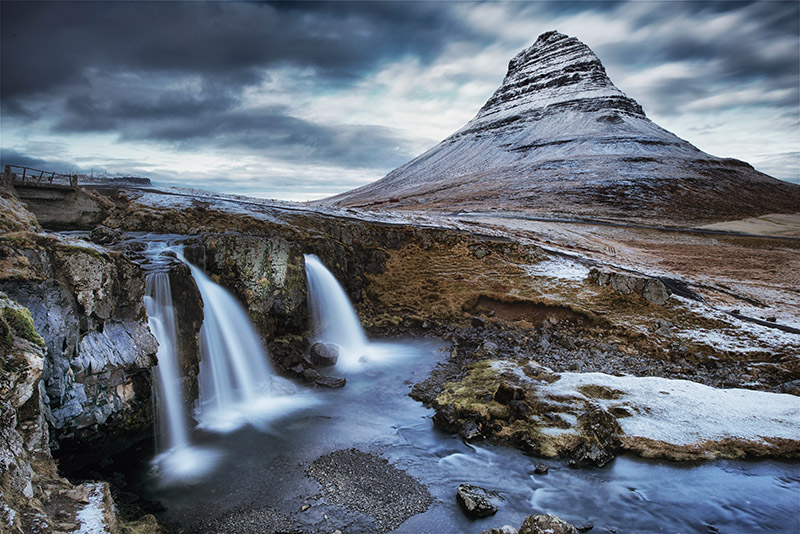 Kirkjufell mountain A small waterfall and Kirkjufell mountain in the back
